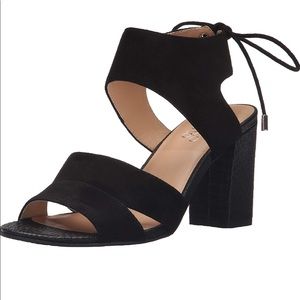 Tan and black block heel sandal with tie in back.